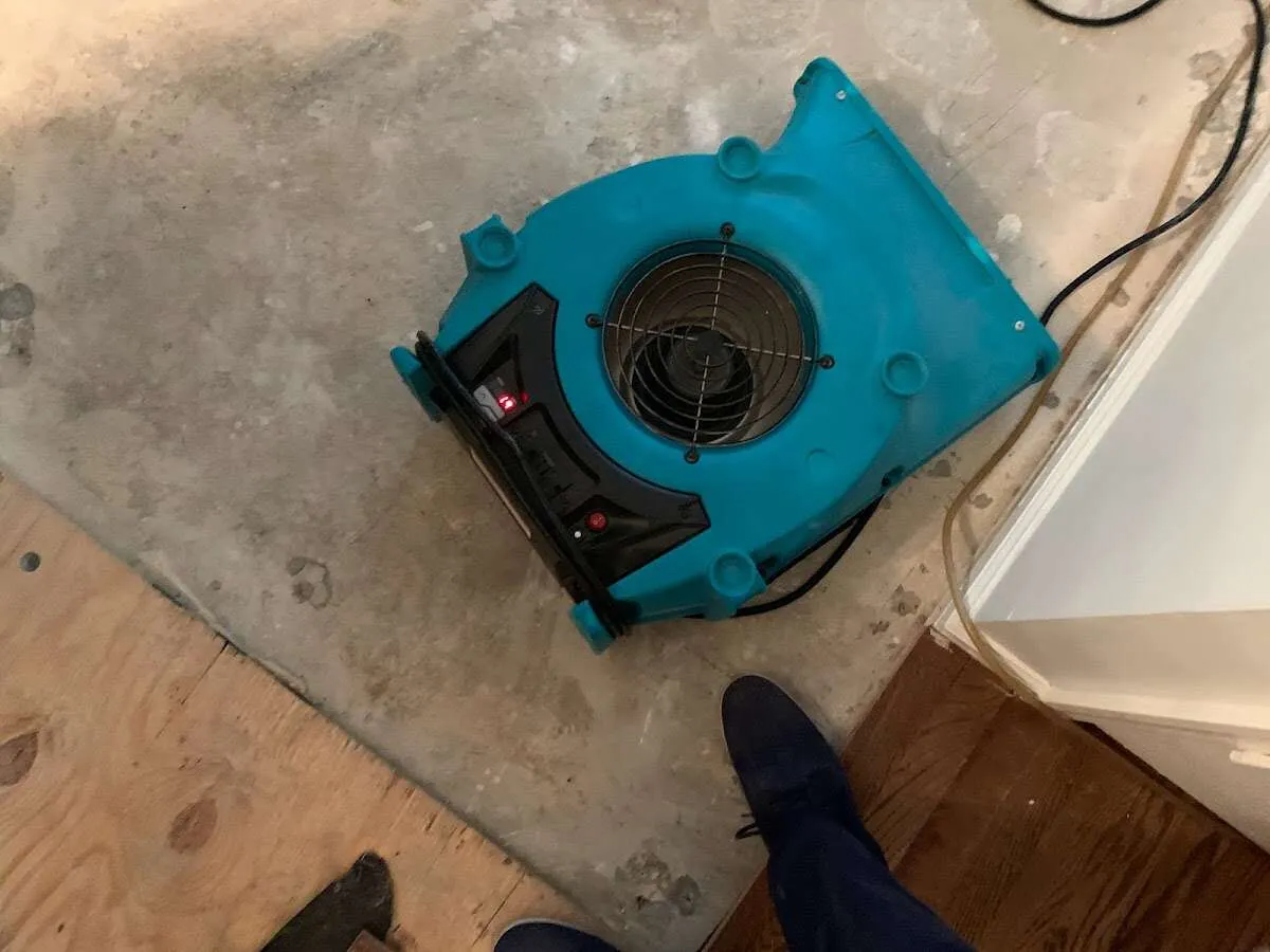 Air mover drying subfloor during Commercial Water Damage Restoration in Woodland